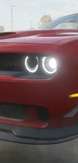 Red sports car with bright headlights at night.