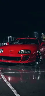 Red sports car against a night backdrop.