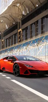 Sleek red sports car on an empty racetrack, ideal for mobile wallpaper.