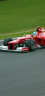 Red sports car racing on a track, showcasing speed and power.