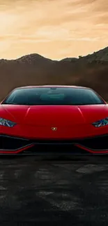 Red sports car on open road with scenic hills and sunset sky.