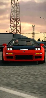 Red sports car on urban road at sunset.