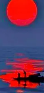 Red sun setting over calm sea with reflection.