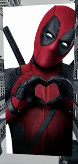 Red-suited superhero forming a heart in an urban background wallpaper.