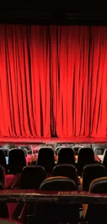 Mobile wallpaper featuring a red theater curtain from a seated perspective.