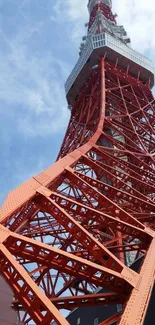 Red steel tower structure against a clear blue sky, showcasing urban architecture.