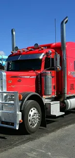 Red semi-truck on a sunny day, perfect for mobile wallpaper.