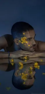 Reflective portrait with yellow flowers on a dark blue background.