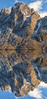 Reflective mountain landscape wallpaper with clear blue sky.