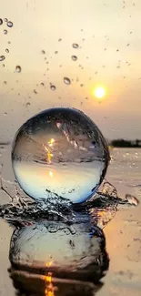 Reflective glass sphere in sunset over water creating a serene scene.