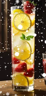 Tall glass of citrus and berry drink with lemon slices and strawberries.