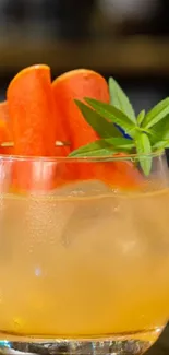 Refreshing citrus cocktail with carrot garnish and mint leaves.