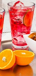 Refreshing red drink with orange and lime slices in a stylish setting.