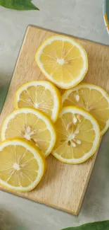 Mobile wallpaper featuring fresh lemon slices on a wooden board.