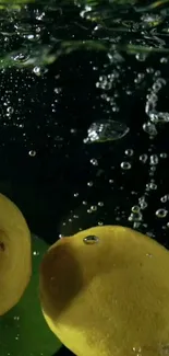 Lemons immersed in sparkling water with bubbles rising.