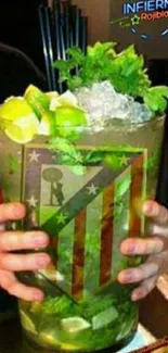 Close-up of a mojito with lime, mint, and ice cubes in a glass.