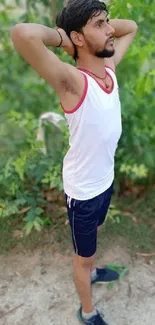 Man exercising in lush green outdoor setting.