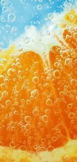 Orange slice wallpaper with bubbles in sparkling water.