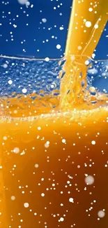 Orange juice splash with bubbles against blue backdrop.