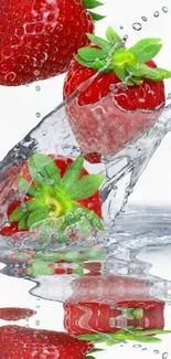 Red strawberries splashing into clear water, creating a dynamic and fresh scene.