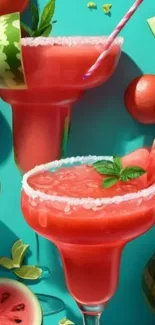 Colorful watermelon cocktails with mint garnish on aqua background.