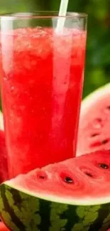 Tall glass of watermelon juice surrounded by slices of fresh watermelon.