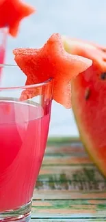 Watermelon drink with star-shaped fruit garnish in glass.