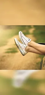 Legs with white sneakers resting on a car window with a natural background.