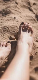 Feet relaxing on sandy beach with warm sunlit tones, perfect for summer vibes.