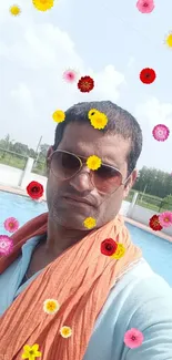 Man in blue shirt by the pool on a sunny day.