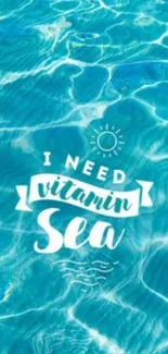 Ocean themed wallpaper with "I need vitamin sea" quote over blue waves.