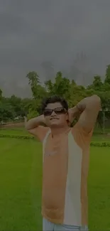 Man relaxing in a lush green park on a bright day.