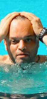 Person relaxing in a blue swimming pool.