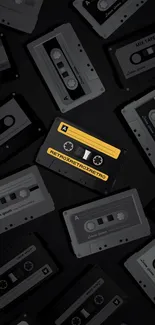 Retro cassette tapes in black and yellow on a mobile wallpaper.