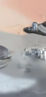 Close-up of a DJ turntable set with gray and beige tones.