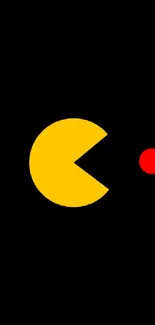 Retro game icon with yellow character and red dot on black background.