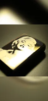 Vintage lighter with artistic portrait on dark background.