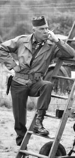 Vintage black and white photo of a soldier on a ladder, deep in thought.