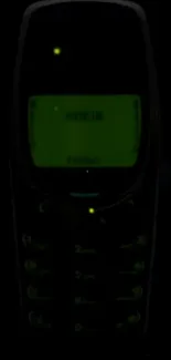 Glowing retro mobile phone on dark background.