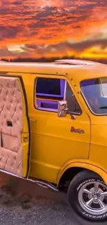 Retro yellow van with scenic sunset background.