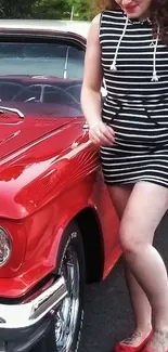 Woman in striped dress with vintage red car.