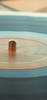 Retro vinyl record spinning on a turntable with a teal aesthetic.