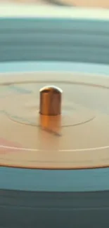 Close-up of a spinning vinyl record with vintage aesthetic in warm tones.