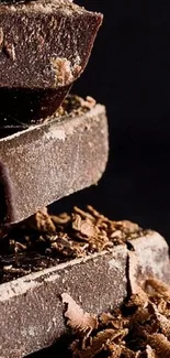 Close-up image of rich, textured dark chocolate on a dark background.