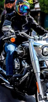 Two people riding a shiny motorcycle down a city street, wearing helmets.