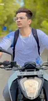 Young man riding motorbike through lush greenery.