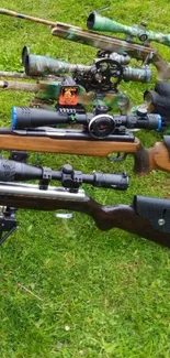 Assorted rifles on lush green grass, perfect for enthusiasts.