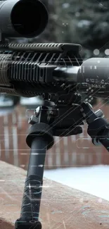 Rifle with scope on wooden railing in winter setting.