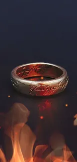 A ring of power floating above flames on dark background.