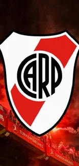 River Plate emblem with stadium lights and red smoke in the background.